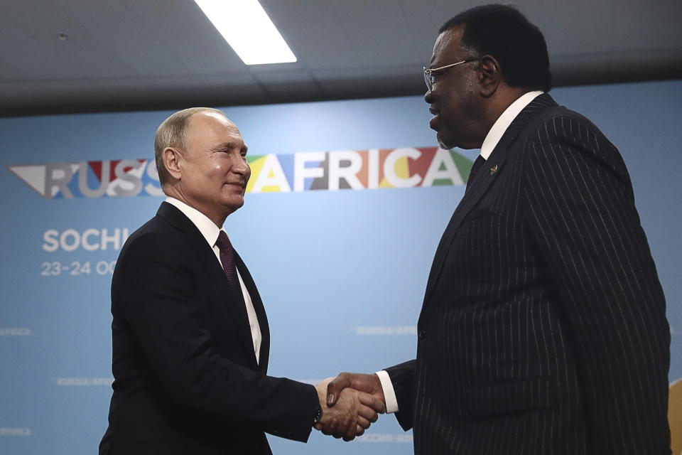 Russian President Vladimir Putin, left, and Namibia's President Hage Geingob shake hands prior to their talks on the sideline of Russia-Africa summit in the Black Sea resort of Sochi, Russia, Wednesday, Oct. 23, 2019. (Sergei Fadeyechev, TASS News Agency Pool Photo via AP)