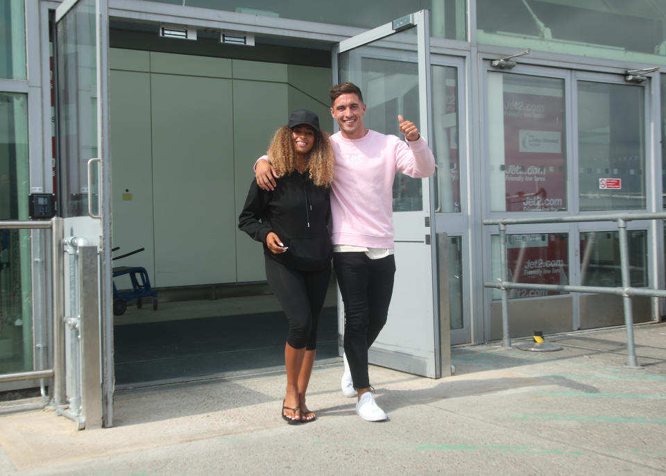 Love Island winners Amber Gill and Greg O'Shea arrive at Stansted Airport in Essex following the final of the reality TV show. (Photo by Yui Mok/PA Images via Getty Images)