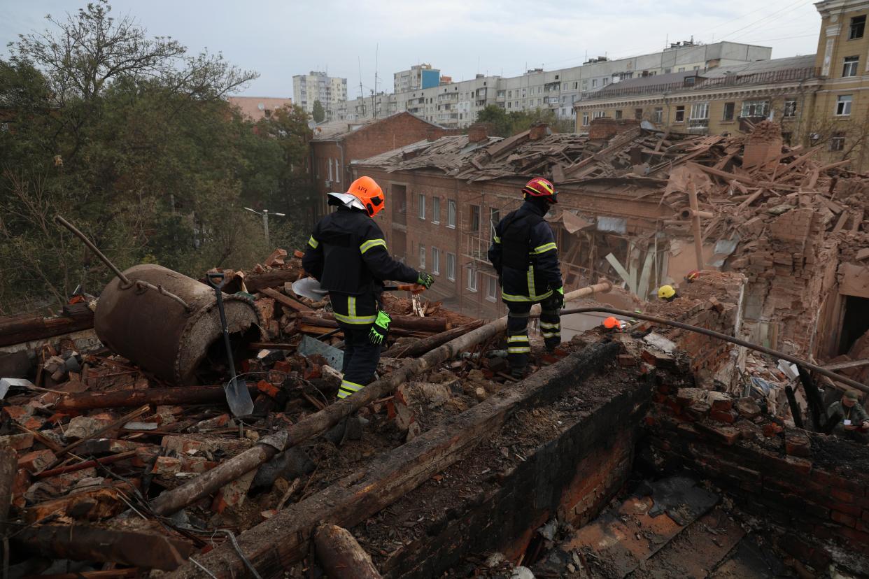 Emergency workers search for victims after a Russian air attack that damaged an apartment building in central Kharkiv (AP)