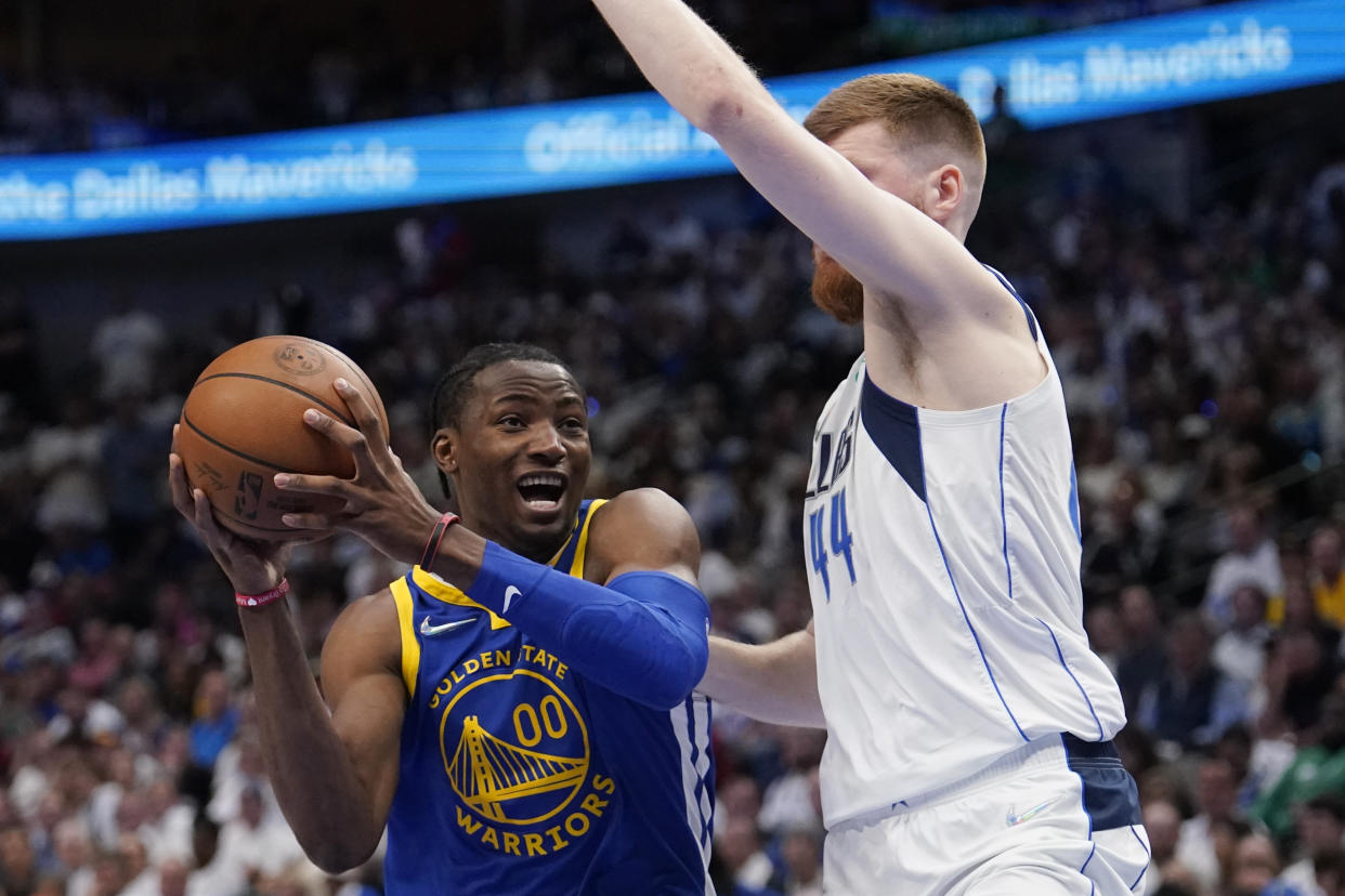 Golden State Warriors forward Jonathan Kuminga is defended by Dallas Mavericks forward Davis Bertans during Game 4 of the NBA's Western Conference finals on May 24, 2022, in Dallas. (AP Photo/Tony Gutierrez)