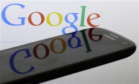 A Google logo is reflected on the screen of a Samsung Galaxy S4 smartphone in this file photo illustration taken in Prague January 31, 2014. REUTERS/David W Cerny/Files