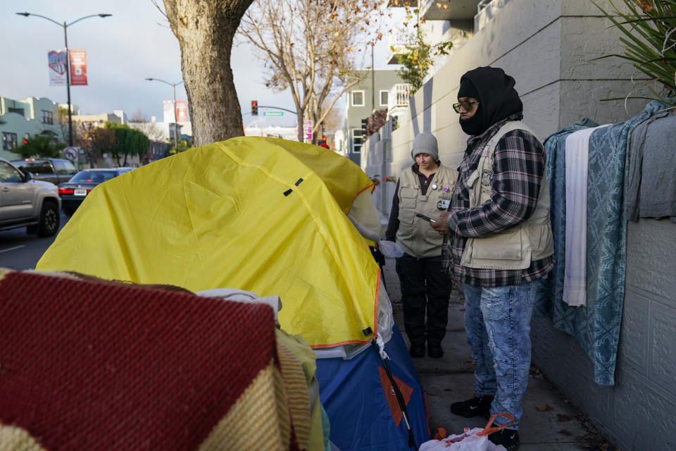 Members of the San Francisco Homeless Outreach Team's Encampment Resolution Team make contact with homeless people in San Francisco, Tuesday, Dec. 13, 2022. (AP Photo/Godofredo A. Vásquez)