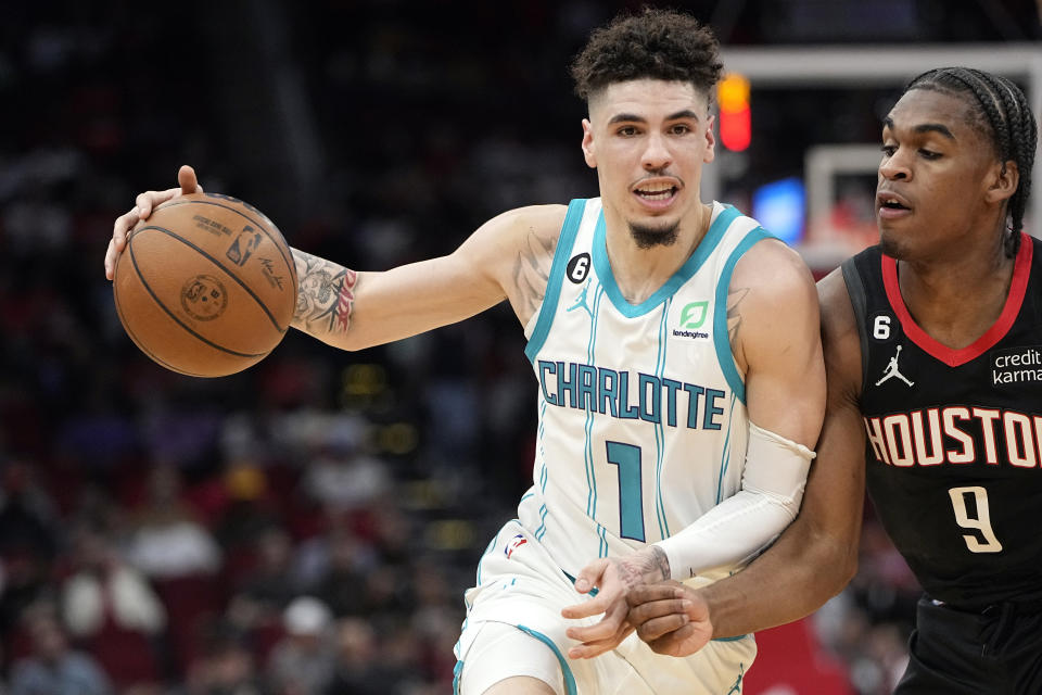 Charlotte Hornets' LaMelo Ball (1) drives toward the basket as Houston Rockets' Josh Christopher (9) defends during the first half of an NBA basketball game Wednesday, Jan. 18, 2023, in Houston. (AP Photo/David J. Phillip)