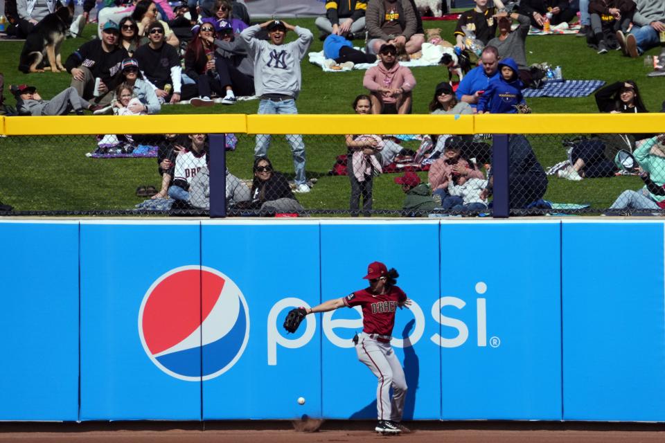 Arizona Diamondbacks center fielder Alek Thomas (5) is unable to track down a fly ball against the San Diego Padres during the first inning at Peoria Sports Complex, Feb. 26, 2023.