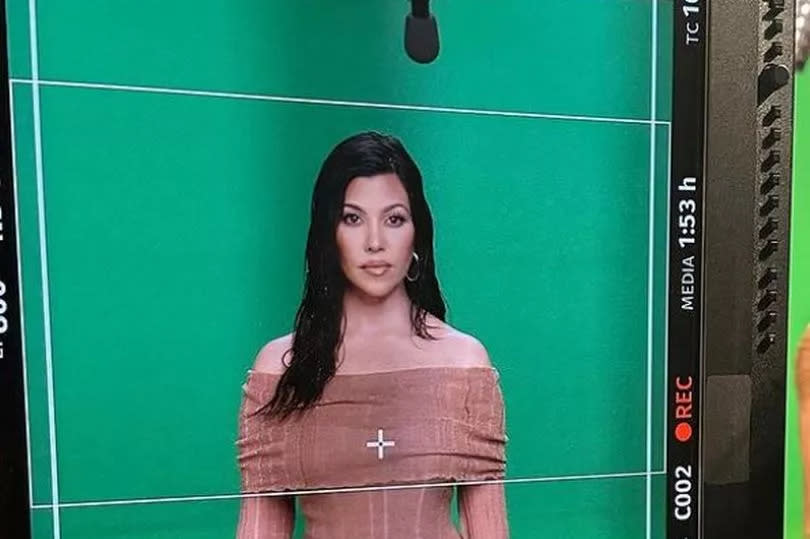 Kourtney Kardashian behind the scenes of a photoshoot