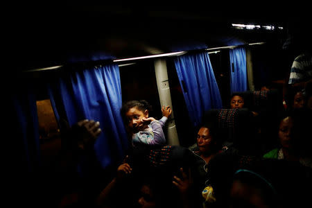 Central American migrants, part of a caravan moving through Mexico toward the U.S. border, sit in a bus bound for Puebla, in Matias Romero, Mexico April 5, 2018. REUTERS/Edgard Garrido