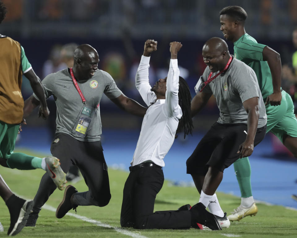Senegal's head coach Aliou Cisse celebrates after the African Cup of Nations semifinal soccer match between Senegal and Tunisia in 30 June stadium in Cairo, Egypt, Sunday, July 14, 2019. (AP Photo/Hassan Ammar)