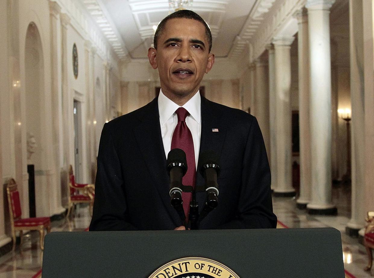 FILE - In this May 1, 2011, file photo, President Barack Obama reads his statement to photographers after making a televised statement on the death of Osama bin Laden from the East Room of the White House in Washington. More than half of Americans view President Barack Obama favorably as he leaves office, a new poll shows, but Americans remain deeply divided over his legacy. Less than half of Americans say they’re better off eight years after his election or that Obama brought the country together. (AP Photo/Pablo Martinez Monsivais, File)