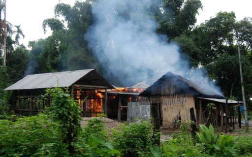 A house burns at Kachugaon village, about 230 kms from Guwahati, the capital city of the northeastern Indian state of Assam during violent clashes on July 23. New clashes took the death toll from ethnic violence in India's remote northeast to 22 on Tuesday despite an official curfew backed by shoot-on-sight orders, police said