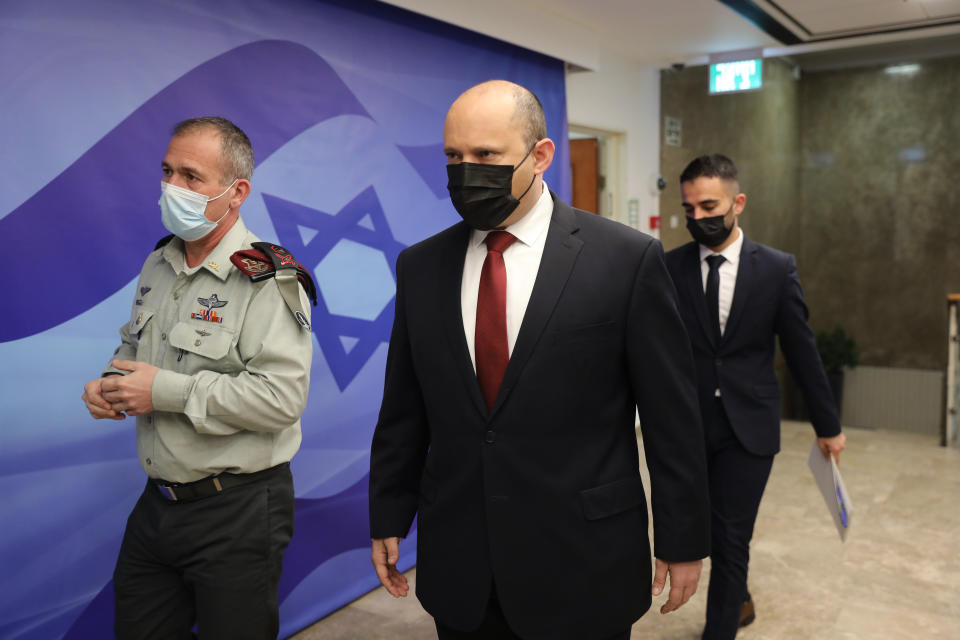 Israeli Prime Minister Naftali Bennett, center, attends a cabinet meeting at the prime minister's office in Jerusalem, Israel, Sunday, Dec. 19, 2021. (Abir Sultan/Pool Photo via AP)