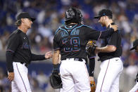 Miami Marlins manager Don Mattingly, left goes to the mound to remove starting pitcher Zach Thompson, right, during the sixth inning of the team's baseball game against the New York Yankees, Friday, July 30, 2021, in Miami. At center is catcher Jorge Alfaro (38). (AP Photo/Lynne Sladky)