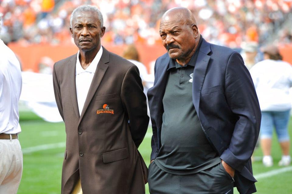 Former players Paul Warfield, left, and Jim Brown stand on the field during a halftime ceremony of a game between the Cleveland Browns and the Baltimore Ravens Sunday, Sept. 21, 2014, in Cleveland.