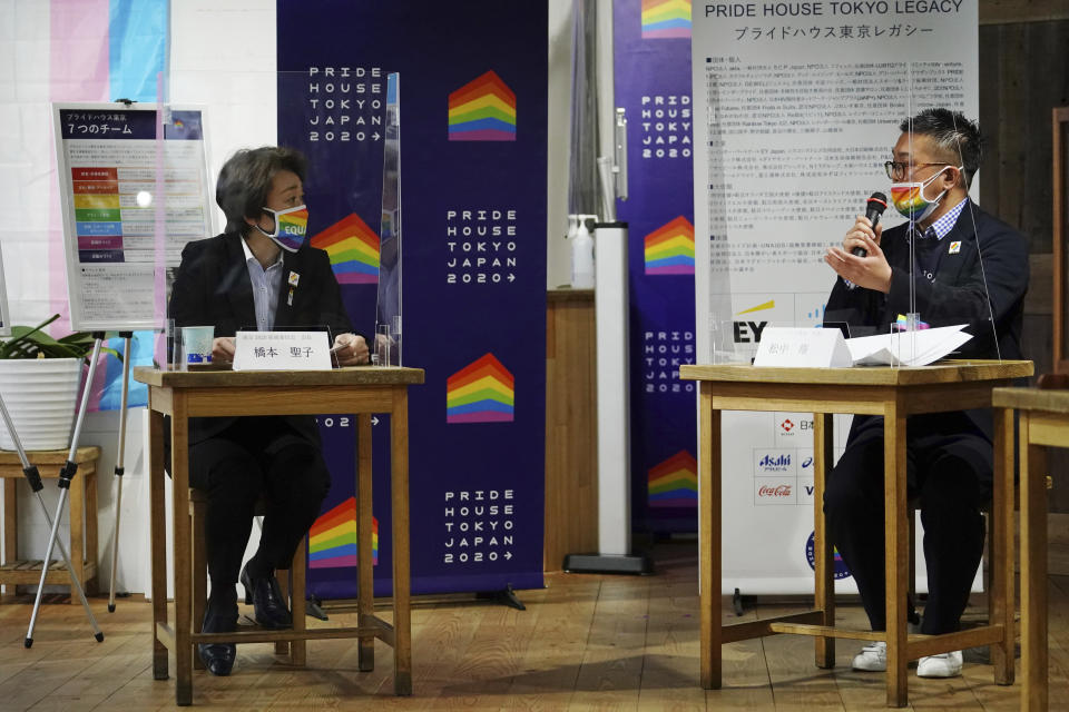 Tokyo 2020 Organizing Committee President Seiko Hashimoto, left, listens to Gon Matsunaka, head of Pride House Tokyo Legacy, during her visit, in Tokyo Tuesday, April 27, 2021. Japan marked LGBTQ week with pledge to push for equality law before the Olympics. (AP Photo/Eugene Hoshiko, Pool)