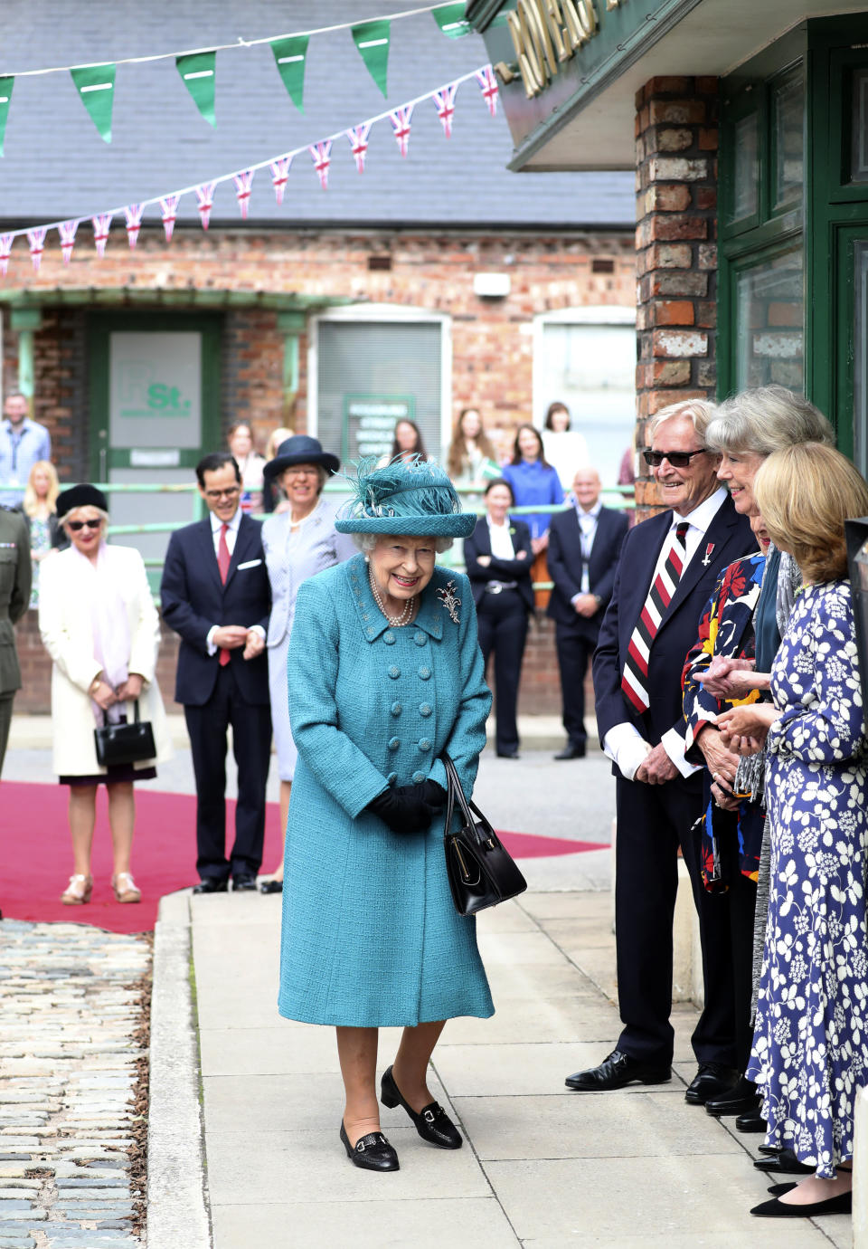 Britain's Queen Elizabeth II visits the set of the long running television series Coronation Street, in Manchester, England, Thursday July 8, 2021. (AP Photo/Scott Heppell)