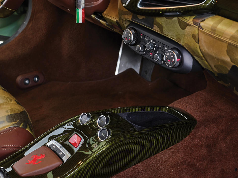 <p>While the interior remains luxuriously carpeted, the dash and central console has also been given the camouflage treatment… </p>