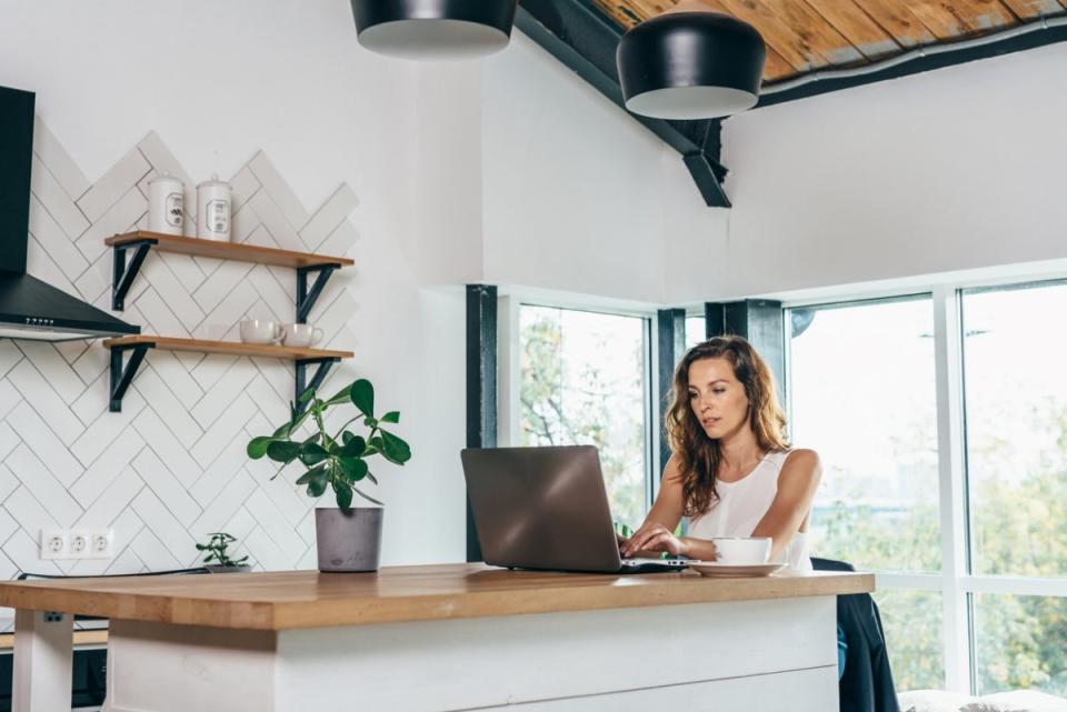 Woman working at kitchen island