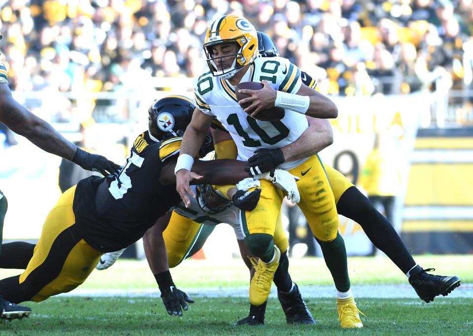 Packers quarterback Jordan Love (10) gets sacked by Steelers linebacker T.J. Watt (90) while defensive tackle Keeanu Benton (95) gets a hand on Love during the second quarter at Acrisure Stadium in Pittsburgh on Nov. 12, 2023.