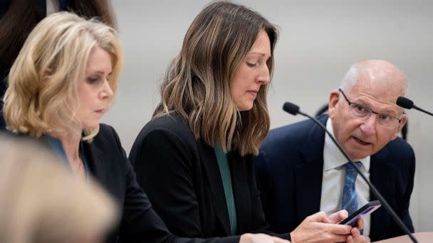 PHOTO: Dr. Caitlin Bernard looks at her phone, May 25, 2023, before a hearing in front of the state medical board at the Indiana Government South building in downtown Indianapolis. (Mykal McEldowney/IndyStar/USA Today Network)