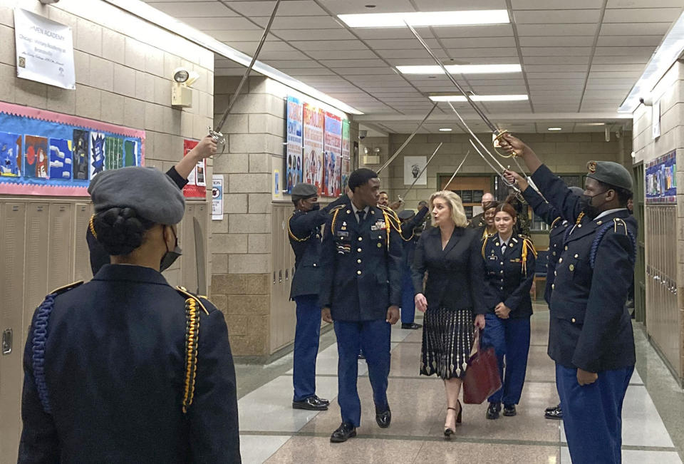 FILE - Army Secretary Christine Wormuth is greeted at the Chicago Military Academy as she heads into meetings with young members of the Reserve Officers' Training Corps in Chicago, on Feb. 15, 2023. The Army and Air Force say they are on track to meet their recruiting goals in 2024, reversing previous shortfalls using a swath of new programs and policy changes. But the Navy, while improving, expects once again to fall short. (AP Photo/Lolita Baldor, File)