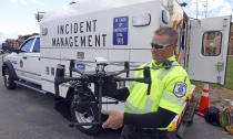 Travis White, Utah Department of Transportation, Highway Incident Management Team, holds a their drone at a drone demo Monday, May 20, 2019, in Park City, Utah. In Utah, drones are hovering near avalanches to watch roaring snow. In North Carolina, they're searching for the nests of endangered birds. In Kansas, they could soon be identifying sick cows through heat signatures. Public transportation agencies are using drones in nearly every state, according to a new survey released Monday, May 20, 2019 by the American Association of State Highway and Transportation Officials. (AP Photo/Rick Bowmer)