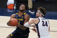 West Virginia's Derek Culver (1) goes to the basket against Gonzaga's Corey Kispert (24) during the first half of an NCAA college basketball game Wednesday, Dec. 2, 2020, in Indianapolis. (AP Photo/Darron Cummings)