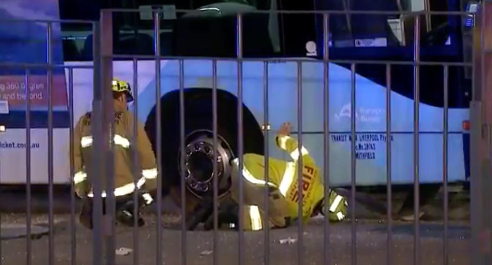 A bus crashed into the bus shelter on the intersection of Argyle and Church streets on Sunday night in Parramatta. Three 16-year-old girls were injured - one pinned underneath. Firefighters are seen checking under the bus.