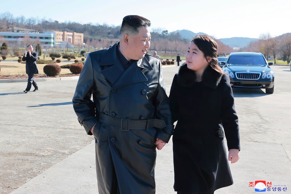 North Korean leader Kim Jong-un and his daughter seen following the launch of an intercontinental ballistic missile, at an unidentified location (Associated Press/ KCNA)