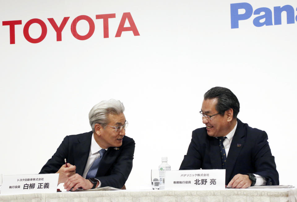 Operating Officer of Toyota Motor Corporation Masayoshi Shirayanagi, left, and Senior Managing Executive Officer of Panasonic Corporation Makoto Kitano talk during a press conference in Tokyo, Thursday, May 9, 2019. Japanese automaker Toyota and electronics maker Panasonic are forming a joint venture combining their housing businesses in Japan. (AP Photo/Koji Sasahara)