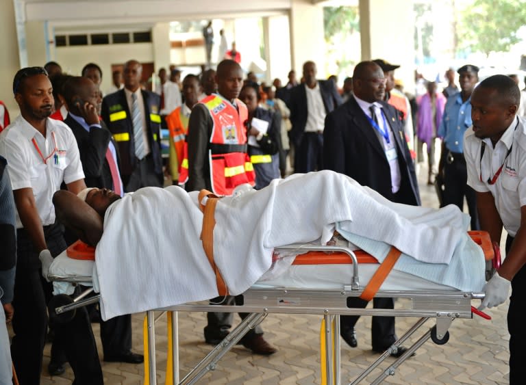 Kenyan paramedics attend to an injured man as he is wheeled into the Kenyatta National Hospital in Nairobi on July 7, 2015, after masked Shebab militants killed at least 14 workers in the remote northern town of Mandera