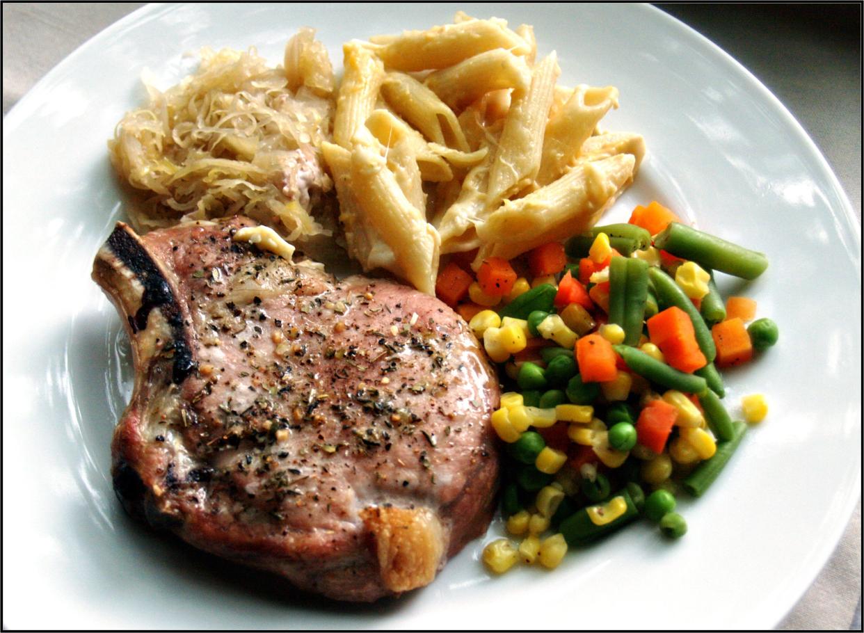 pork chops seasoned with herbs de provence, with sauerkraut (a very baltimore sort of thing) and steamed veggies, with a little bit of cheesy pasta leftover from a different meal.