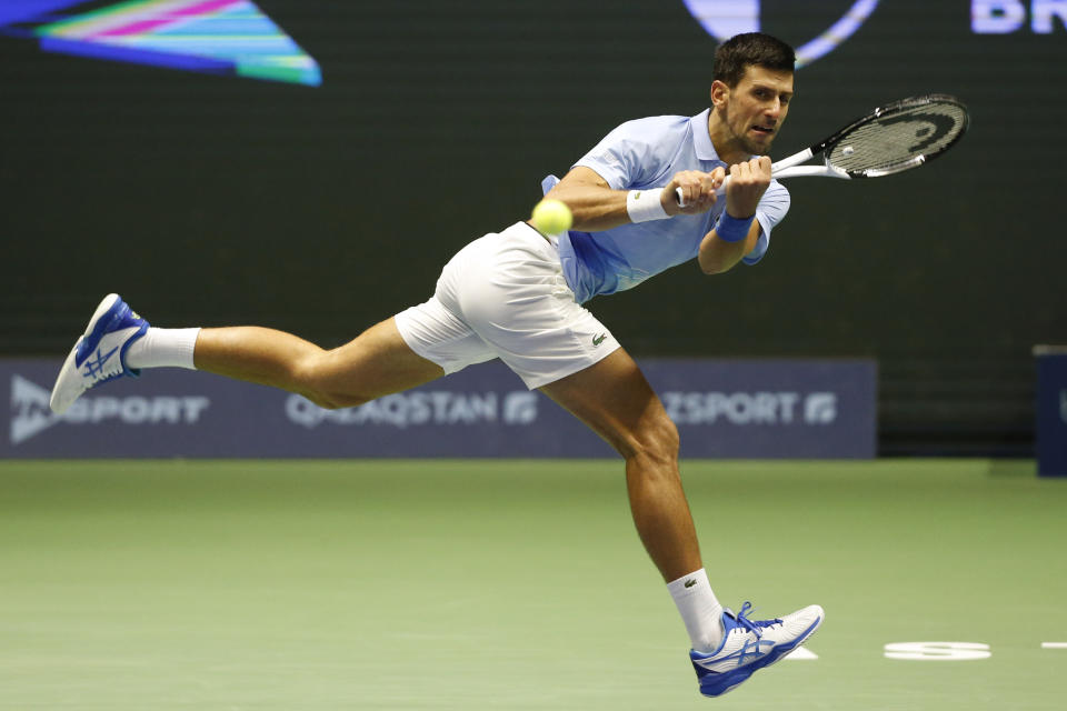 Serbia's Novak Djokovic returns the ball to Stefanos Tsitsipas of Greece during their ATP 500 Astana Open tennis tournament final match in Astana, Kazakhstan, Sunday, Oct. 9, 2022. (AP Photo/Stas Filippov)