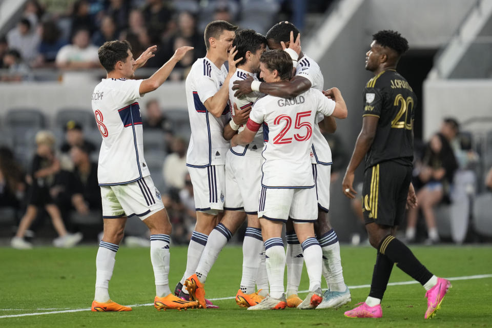 Vancouver Whitecaps forward Brian White (24) celebrates with teammates after scoring during the first half of an MLS soccer match against Los Angeles FC in Los Angeles, Saturday, June 24, 2023. (AP Photo/Ashley Landis)