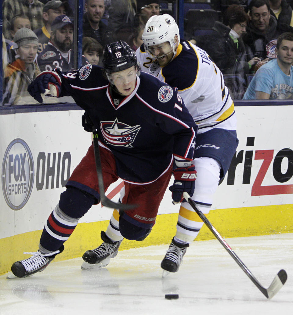 Buffalo Sabres' Henrik Tallinder, right, of Sweden, tries to steal the puck from Columbus Blue Jackets' Ryan Johansen during the second period of an NHL hockey game, Saturday, Jan. 25, 2014, in Columbus, Ohio. (AP Photo/Jay LaPrete)