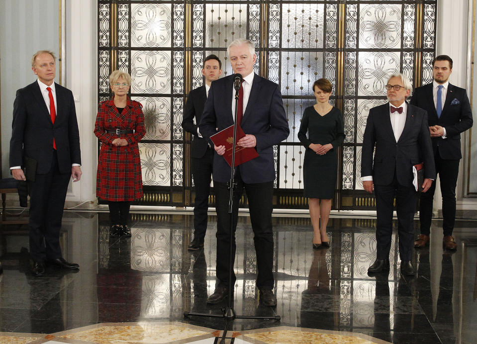 Jaroslaw Gowin, center, the head of a faction within the ruling conservative coalition, speaks to reporters about his proposal to postpone a presidential election in Poland by two years in Warsaw, Poland, Friday April 3, 2020. Uncertainty deepened in Poland on Friday over whether the country will move forward with a presidential election scheduled for May despite the coronavirus pandemic.(AP Photo/Czarek Sokolowski)