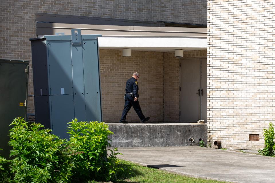 A Corpus Christi police officer walks around Del Mar College's Heritage Campus after a hoax active shooter call on Thursday, April 13, 2023, in Corpus Christi, Texas.