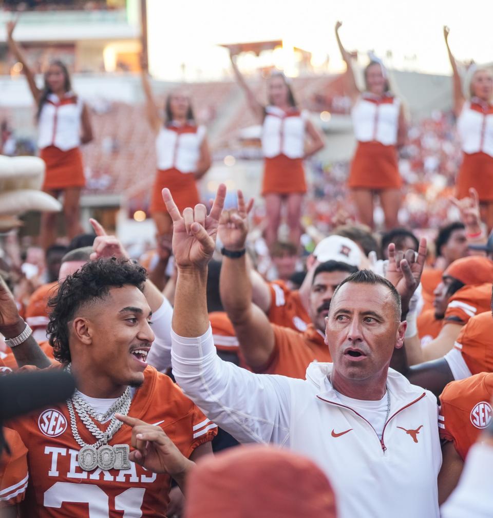 Texas football coach Steve Sarkisian joins his players to sing "The Eyes of Texas" after the Texas Longhorns beat Mississippi State Saturday at Royal-TMemorial Stadium in Austin. With an open date this weekend, Sarkisian will hit the recruiting path.