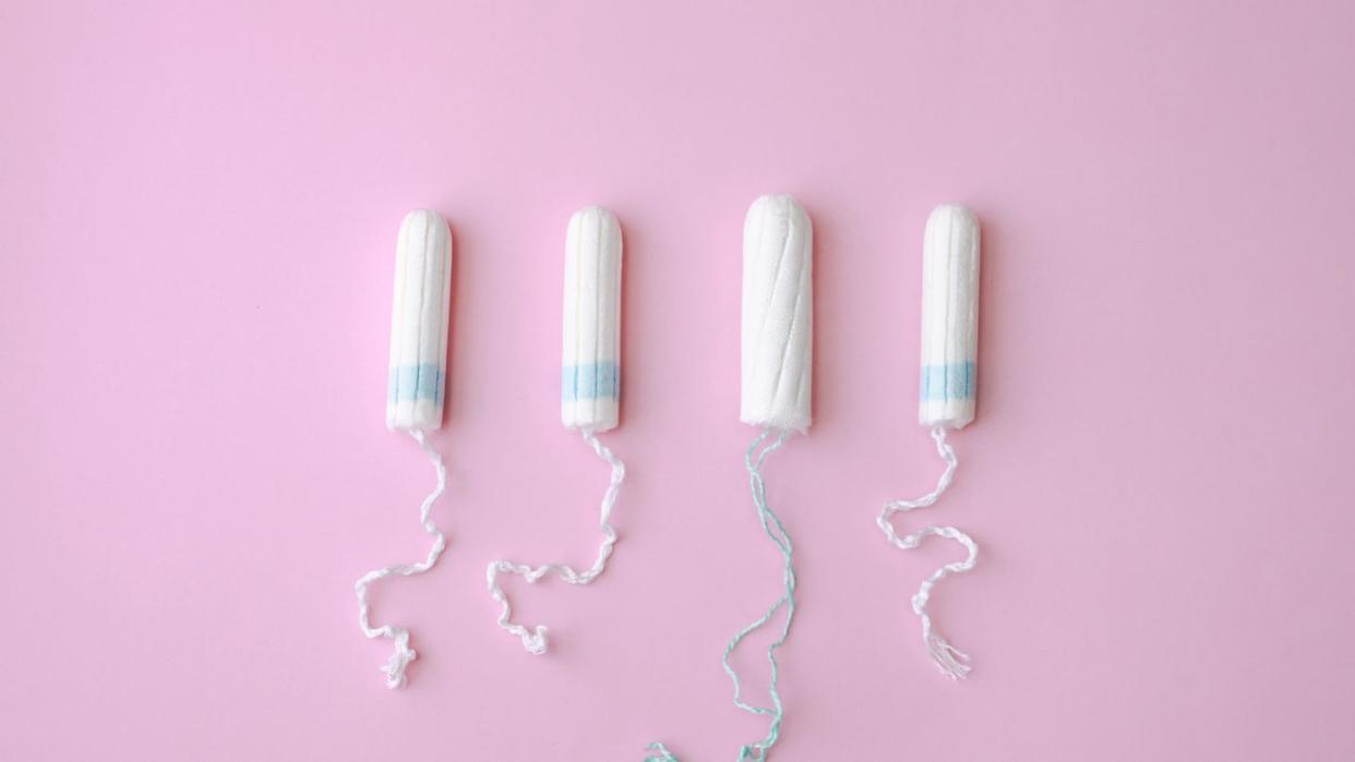 sanitary tampons for menstruation period over pink background female health care concept