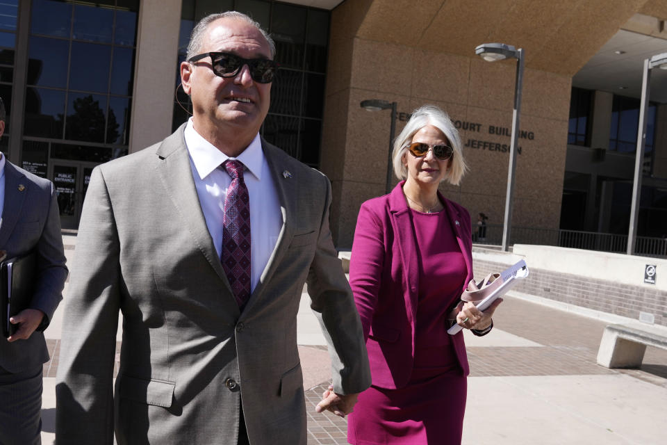 Former Arizona Republican Party chair Kelli Ward, right, with husband Michael Ward, walk out of Maricopa County Superior Court after their arraignment as they joined at least 10 other people who were also arraigned for conspiracy, forgery and fraud charges role in an effort to overturn Donald Trump's 2020 election loss in Arizona to Joe Biden Tuesday, May 21, 2024, in Phoenix. (AP Photo/Ross D. Franklin)