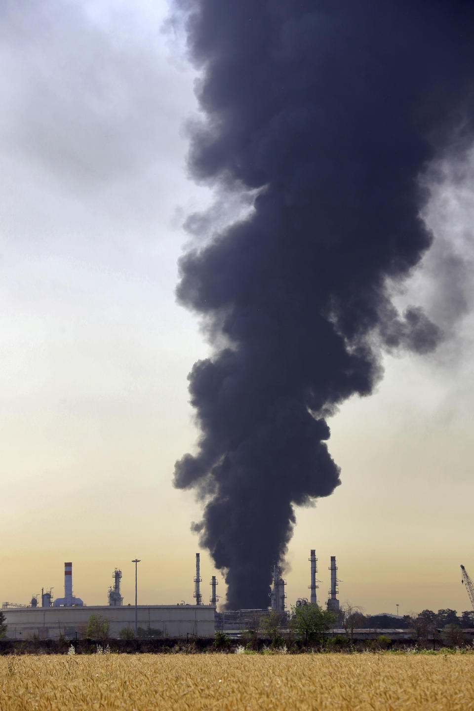 Huge plumes of smoke rise up from Tehran's main oil refinery south of Tehran, Iran, Thursday, June 3, 2021. A massive fire broke out Wednesday night at the oil refinery serving Iran's capital, sending thick plumes of black smoke over Tehran. (AP Photo/Ebrahim Noroozi)