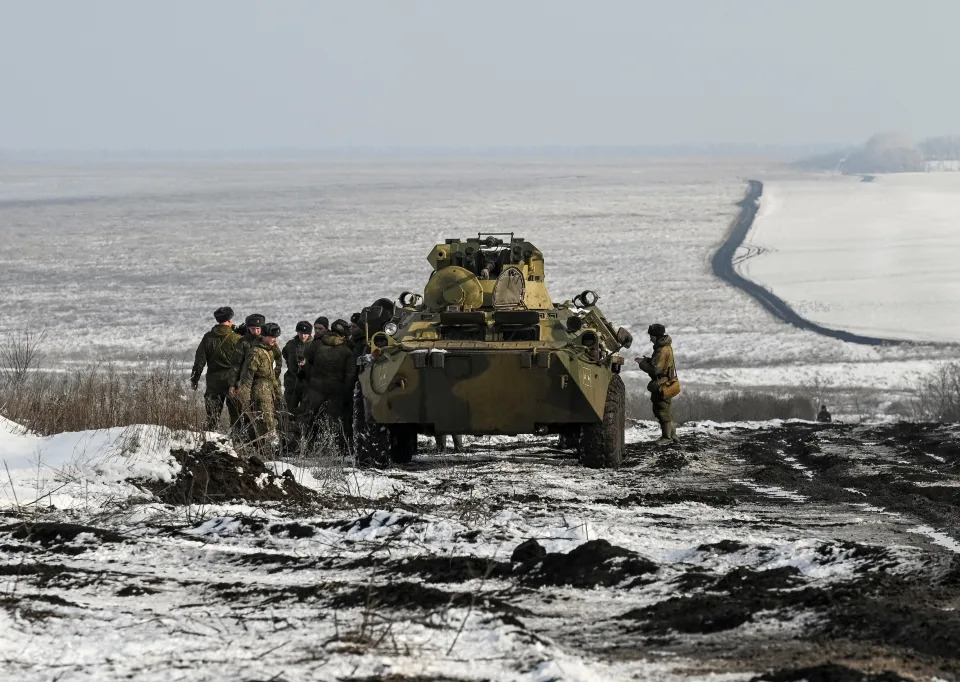 Russian army service members are seen next to an armoured personnel carrier BTR-82 during drills at the Kuzminsky range in the southern Rostov region, Russia January 26, 2022. REUTERS/Sergey Pivovarov