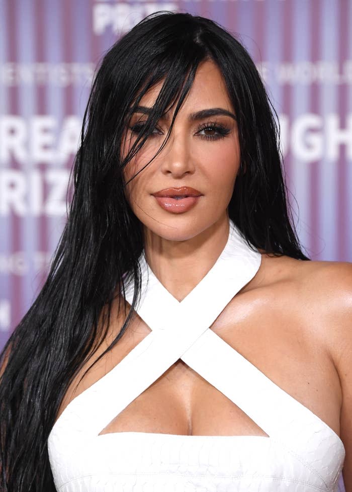 Portrait of Kim Kardashian in a white crisscross halter top at an event