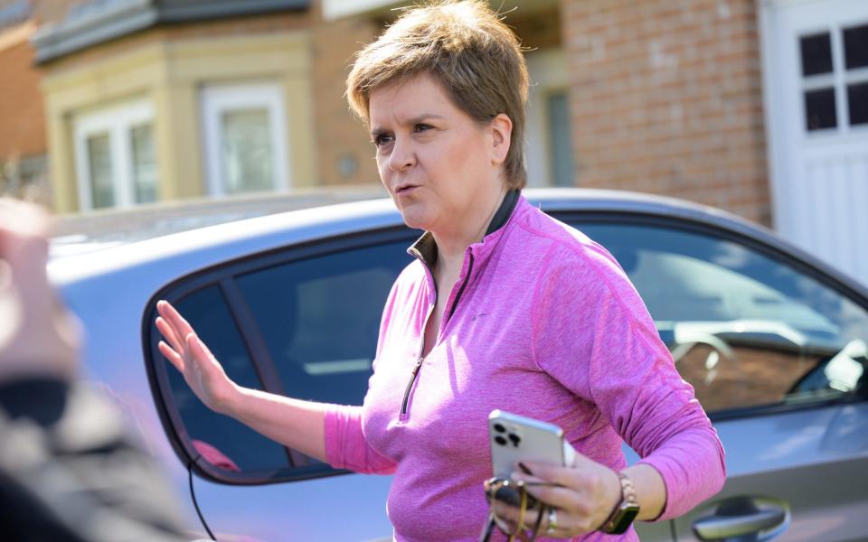 Nicola Sturgeon speaks to reporters outside her home on Friday