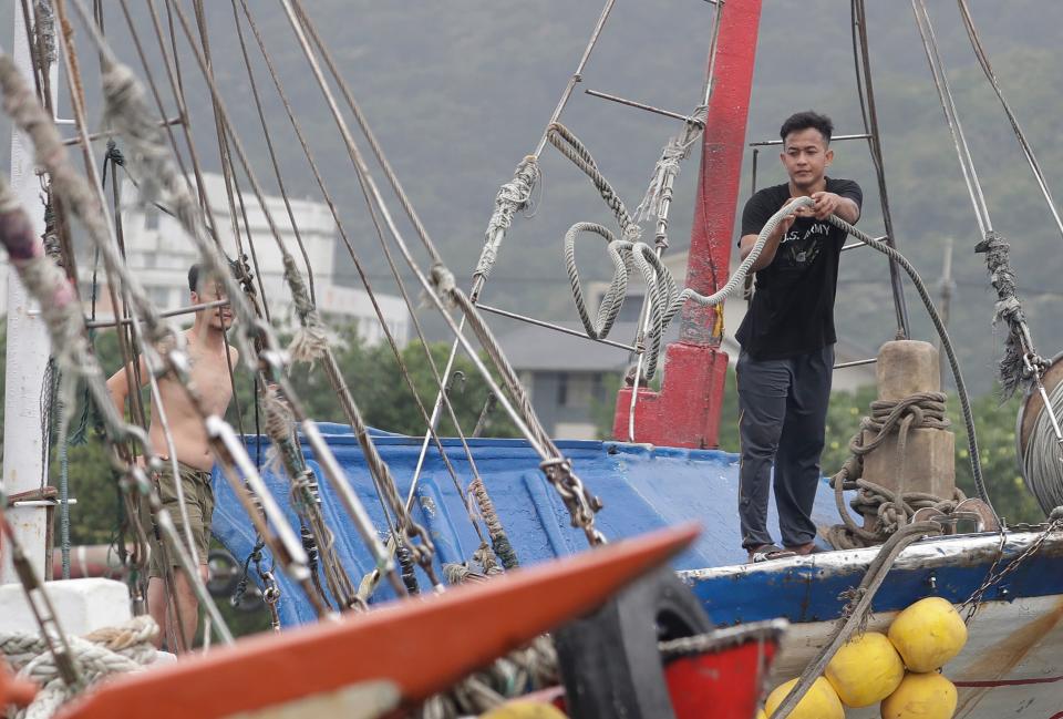 A fisherman fastens a boat as Typhoon Mawar approaches to Taiwan in Yilan County (AP)