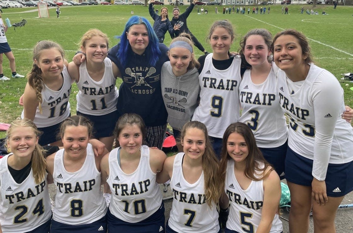 Members of the Traip Academy girls lacrosse team celebrate after Friday's 13-11 win over Noble in a Class C South contest. It was the first victory in program history for the Rangers.