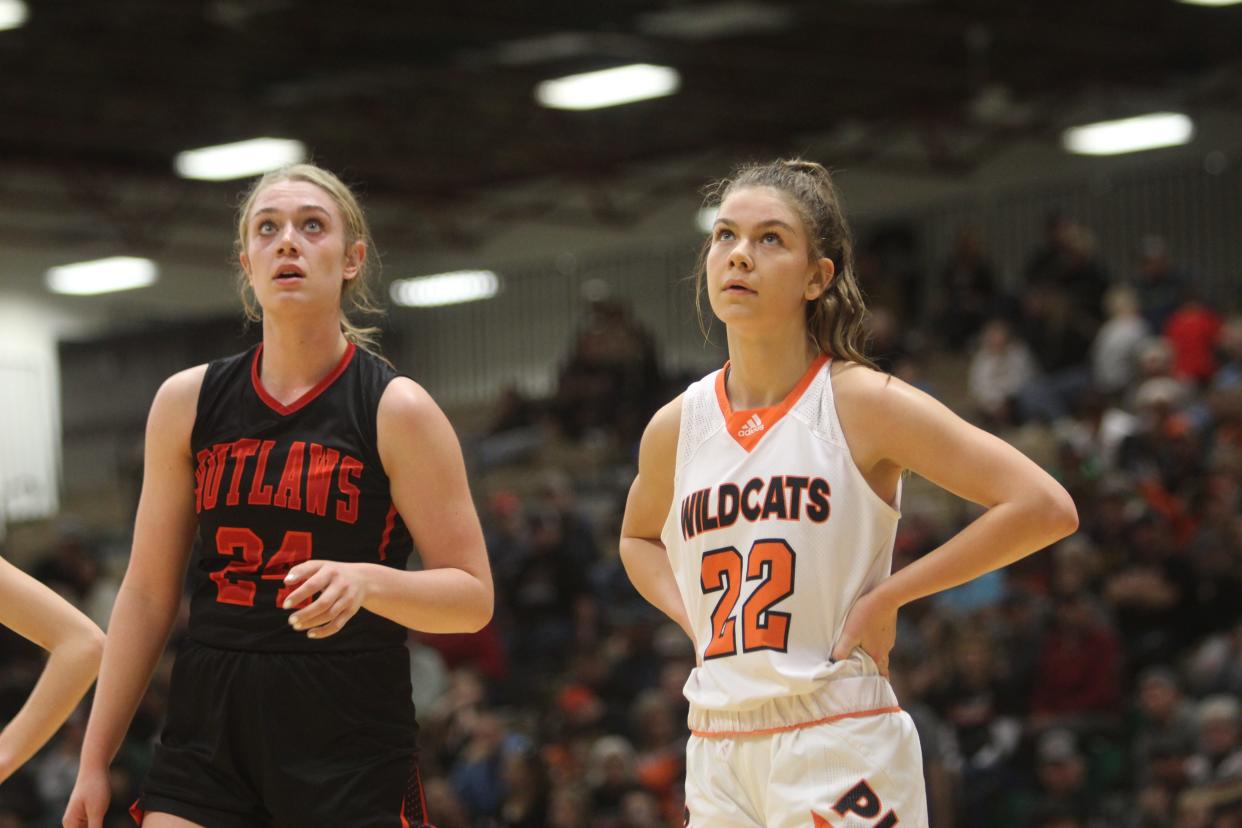 Roy-Winifred standout Madeline Heggem and Plentywood's Liv Wangerin take a breather during the 2022 Class C state tournament opening round last March. Both were named to the Tribune Super State girls' basketball team.