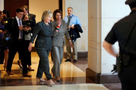 Democratic U.S. presidential candidate Hillary Clinton (L) and U.S. House Minority Leader Nancy Pelosi (D-CA) leave a House Democratic Caucus meeting on Capitol Hill in Washington, U.S., June 22, 2016. REUTERS/Carlos Barria