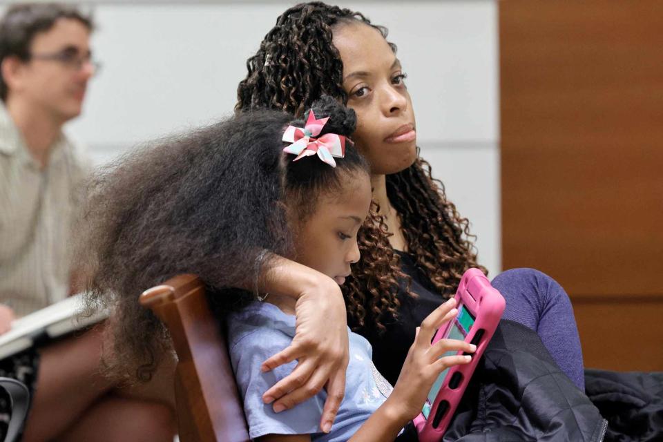 <p>Mike Stocker/South Florida Sun Sentinel/Tribune News Service via Getty</p> Philana Holmes and her daughter Olivia Caraballo listen to the final witness in their case at the Broward County Courthouse in Fort Lauderdale 