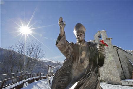 A statue of the late Pope John Paul II is seen in front of the small mountain church of San Pietro della Ienca, near the city of L'Aquila January 28, 2014. Thieves broke into a small church in the mountains east of Rome over the weekend and stole the reliquary with the blood of the late Pope John Paul II, a custodian said on Monday. REUTERS/Max Rossi