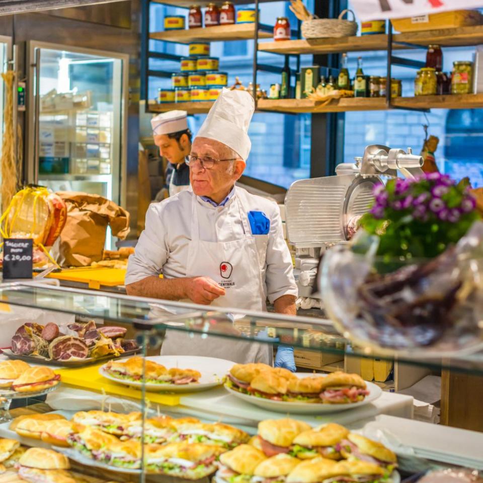 Two Italian men serving sandwiches at Mercato Centrale Roma next to Roma Termini railway station, Rome, Lazio, Italy.