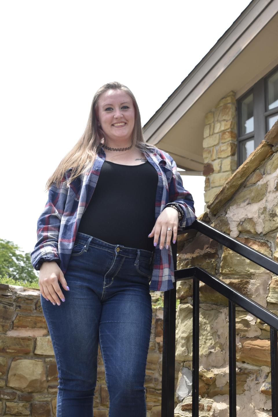 Kaylee May poses outside a treatment services facility in Bloomington where the mother of two works to help people overcome addictions.